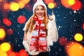 Christmas and New Year holidays. Happy woman holding gift boxes on winter background with snow and lights in black Royalty Free Stock Photo