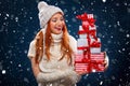 Christmas and New Year holidays. Happy woman holding gift boxes on winter background with snow in black friday. Sales on Royalty Free Stock Photo