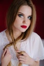 Young woman in white dress posing by the background