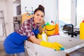 Beautiful young woman makes cleaning the house. Girl cleaning kitchen. Set. Royalty Free Stock Photo