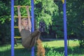 Beautiful young woman makes sport exercises on the sport ground, blurred background