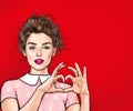 Beautiful young woman making heart with her hands on red background. Positive human emotion expression feeling life body language.