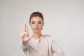 Beautiful young woman making stop gesture