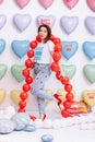 Beautiful young woman on many colorful heart balloons background. smiles,funny Valentine s Day birthday party Royalty Free Stock Photo