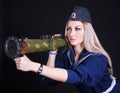 Beautiful young woman in a marine uniform with a grenade launcher