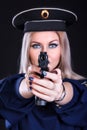 Beautiful young woman in a marine uniform with a gun (focus is o