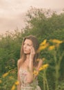 Beautiful Young Woman in Meadow of Flowers. Royalty Free Stock Photo