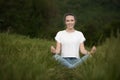 Beautiful young woman meditate on meadou na early summer evening Royalty Free Stock Photo