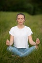 Beautiful young woman meditate on meadou na early summer evening Royalty Free Stock Photo