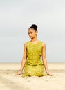 Beautiful young woman meditating at the beach Royalty Free Stock Photo