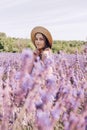 Beautiful young woman in the middle of a blooming lavender field