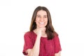 Beautiful young woman model looking at camera with charming cute smile posing over white copy space wall Royalty Free Stock Photo