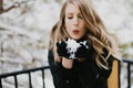 Beautiful Young Woman Modeling Bundled in Trendy Gloves, Coat, and Scarf Smiling and Having Fun With Snow Outside in Nature Around Royalty Free Stock Photo