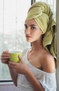 Beautiful young woman with morning cup of hot beverage. Royalty Free Stock Photo