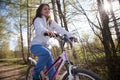 Beautiful young woman with mountain bicycle in spring forest Royalty Free Stock Photo