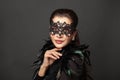 Beautiful young woman in mysterious black Venetian mask. Fashion photo Royalty Free Stock Photo