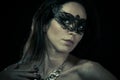 Beautiful young woman in mysterious black Venetian mask Royalty Free Stock Photo