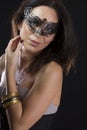 Beautiful young woman in mysterious black Venetian mask Royalty Free Stock Photo