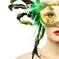 Beautiful young woman in mysterious golden Venetian mask Royalty Free Stock Photo