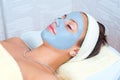 Beautiful young woman with natural facial mask