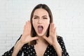 Beautiful young woman near brick wall Royalty Free Stock Photo