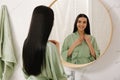 Beautiful young woman near mirror in bathroom Royalty Free Stock Photo