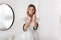 Beautiful young woman near mirror in room Royalty Free Stock Photo