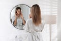 Beautiful young woman near mirror in room Royalty Free Stock Photo