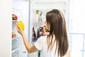 Healthy eating concept. Diet. Beautiful young woman near the refrigerator with healthy food. Fruits and vegetables in a Fridge Royalty Free Stock Photo