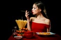 Beautiful young woman with noodles spaghetti, sexy kitchen. Royalty Free Stock Photo