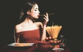 Beautiful young woman with noodles spaghetti, sexy kitchen. Royalty Free Stock Photo