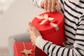 Beautiful young woman opening gift box at home, closeup Royalty Free Stock Photo