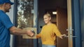 Beautiful Young Woman Opens Doors of Her House and Meets Delivery Man who Gives Her Cardboard Box Royalty Free Stock Photo