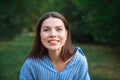 Beautiful Young Woman Outdoors. Enjoy Nature. Healthy Smiling Girl in Green Grass. Face young beautiful girl dark closeups short Royalty Free Stock Photo