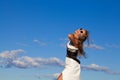 Beautiful Young Woman over blue Sky