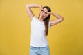 Beautiful young woman over yellow background happy face smiling doing ok or glass sign with hand on eye looking through Royalty Free Stock Photo