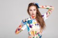 Young woman smeared in multicolored paint. Royalty Free Stock Photo