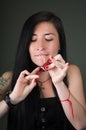 Beautiful young woman painting her nails with red lacquer Royalty Free Stock Photo