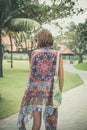 Beautiful young woman in pareo and swimsuit walking in the becah park with bag on sunny summer day. Tropical island Bali Royalty Free Stock Photo