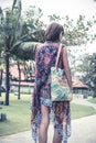 Beautiful young woman in pareo and swimsuit walking in the becah park with bag on sunny summer day. Tropical island Bali Royalty Free Stock Photo