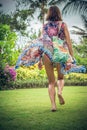 Beautiful young woman in pareo and swimsuit walking in the becah park with bag on sunny summer day. Tropical island Bali Royalty Free Stock Photo