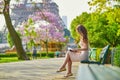 Beautiful young woman in Paris, reading a book Royalty Free Stock Photo