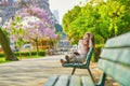 Beautiful young woman in Paris, reading a book Royalty Free Stock Photo