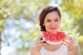 Beautiful young woman at park eating a slice of watermelon Royalty Free Stock Photo