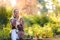 Beautiful young woman in the park using smart phone listening music over headphones Royalty Free Stock Photo