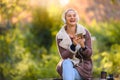 Beautiful young woman in the park using smart phone listening music over headphones Royalty Free Stock Photo