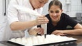 Beautiful young woman pastry chef smiling to the camera at the bakery kitchen