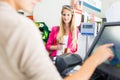 Beautiful young woman paying for her groceries