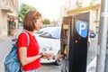 Young woman pays for Parking her car at the street Royalty Free Stock Photo