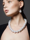 Beautiful young woman with pearl jewelry